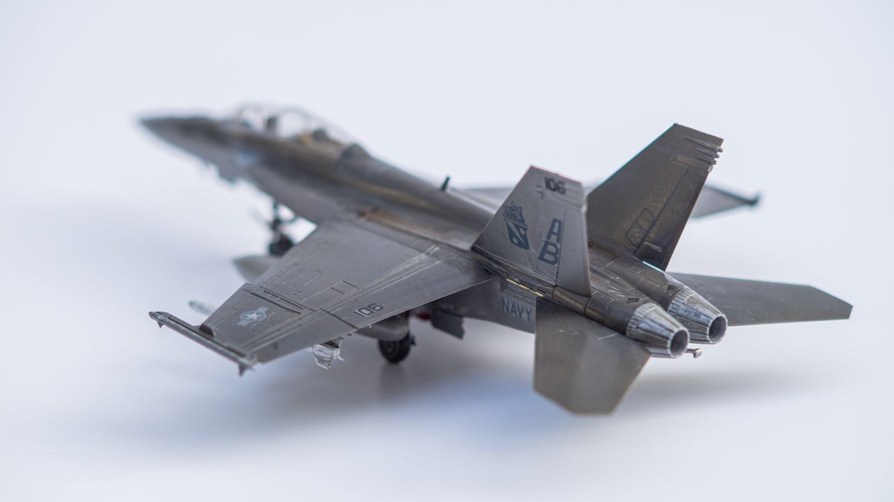 About Close-up of a miniature fighter jet model on a white background.