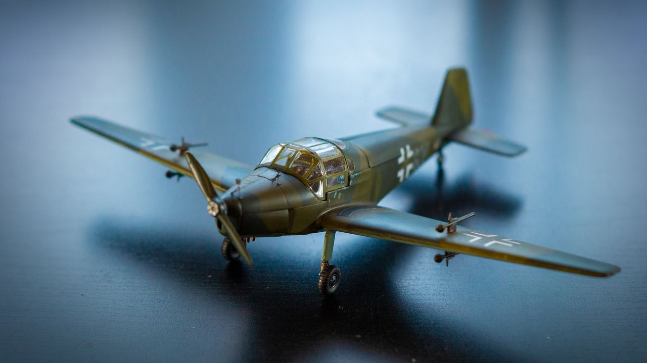About Close-up of a realistic model airplane with propeller on a dark surface, showcasing intricate details.