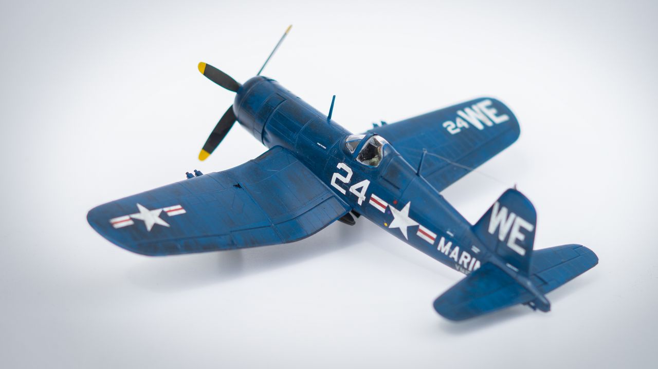 The Art of Drawing Readers In: Your attractive post title goes here Close-up of a navy blue model airplane with military markings on a white background.