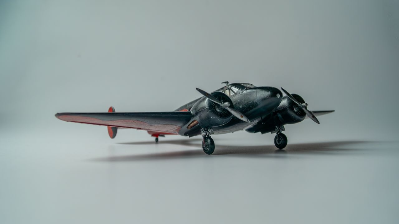 Services Close-up of a vintage model airplane with twin propellers, capturing its intricate details.